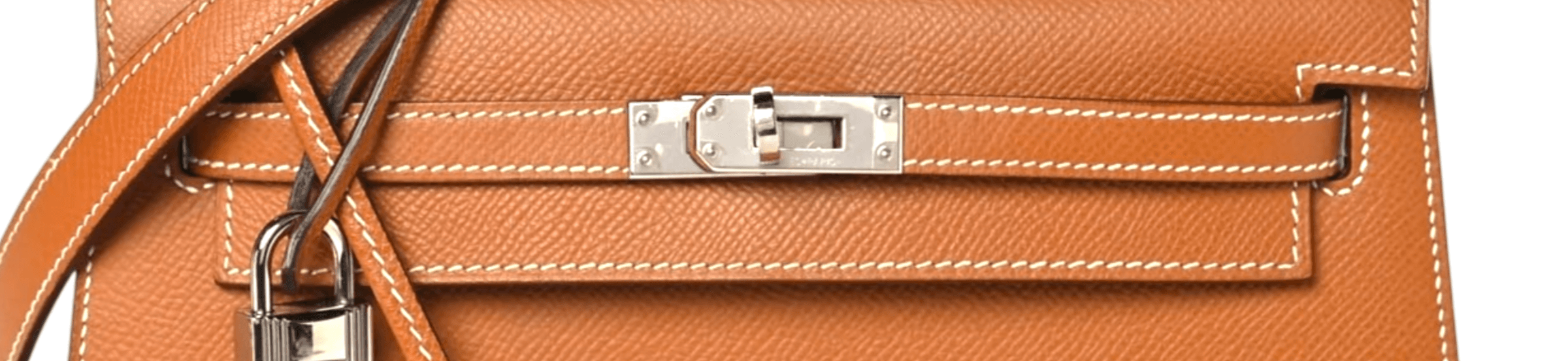 Contrast saddle stitching along the strap band and flap of a Gold Kelly