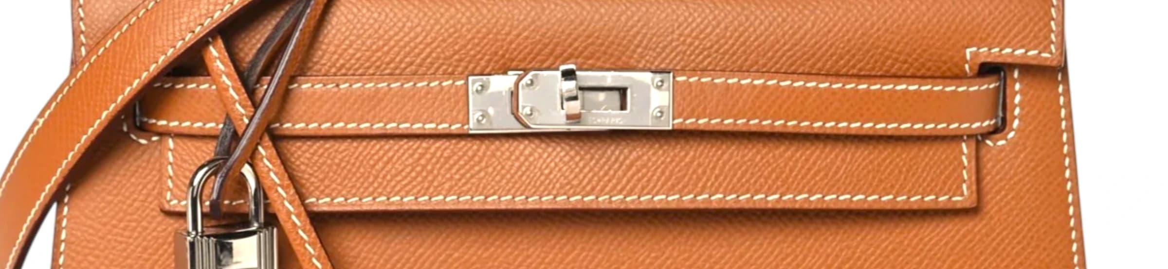 Contrast saddle stitching along the strap band and flap of a Gold Kelly